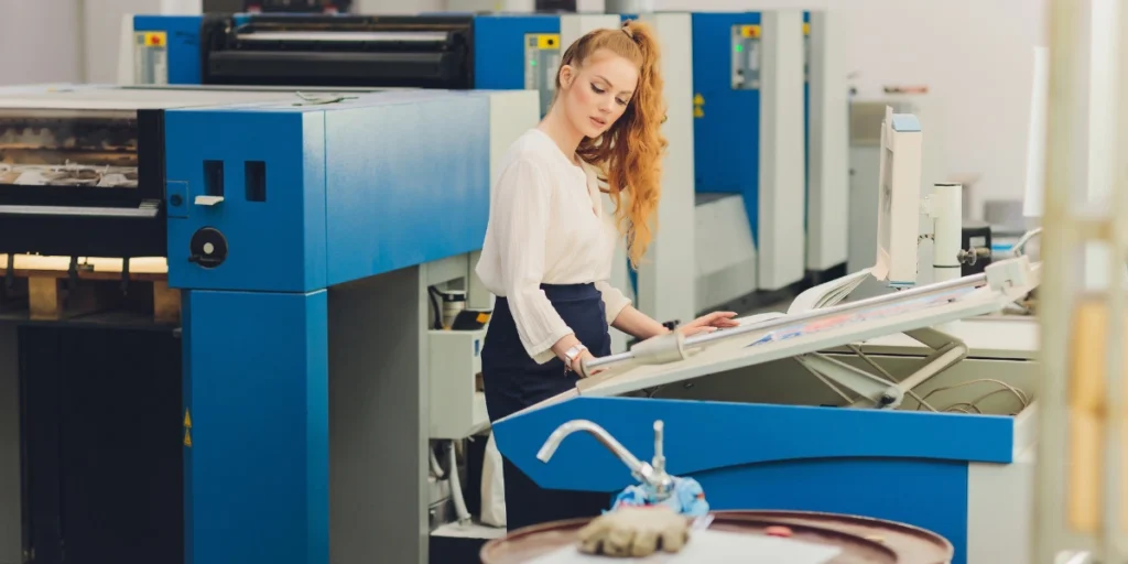 Professional operator managing printing machine – Digital Printing Services in UAE for quality prints.